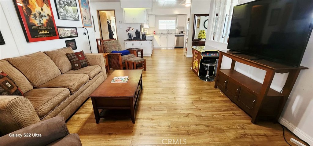 8651 Foothill Boulevard, Unit 159 Rancho Cucamonga, CA 91730 - Photo 7 of 18 a living room with furniture a flat screen tv and a fireplace