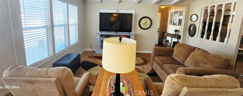 8651 Foothill Boulevard, Unit 159 Rancho Cucamonga, CA 91730 - Photo 8 of 18 a living room with furniture and a window
