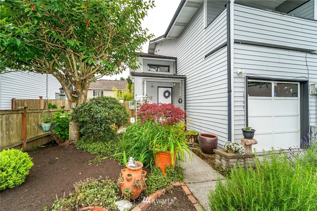 4109 Northeast 5th Street Renton, WA 98059 - Photo 1 of 26 a front view of a house with a yard