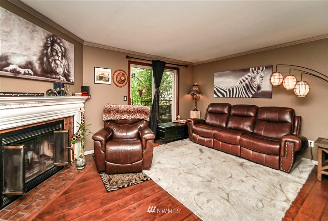 4109 Northeast 5th Street Renton, WA 98059 - Photo 14 of 26 a living room with furniture a fireplace and a large window