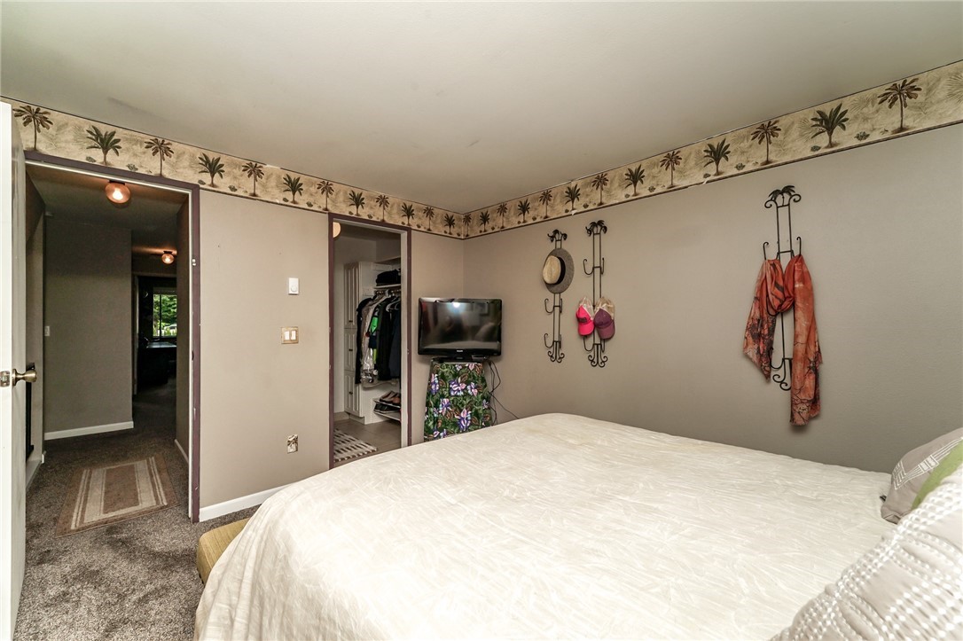 4109 Northeast 5th Street Renton, WA 98059 - Photo 21 of 26 a bedroom with a large bed and a large mirror