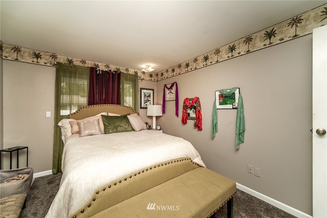 4109 Northeast 5th Street Renton, WA 98059 - Photo 22 of 26 a bedroom with a bed and a table