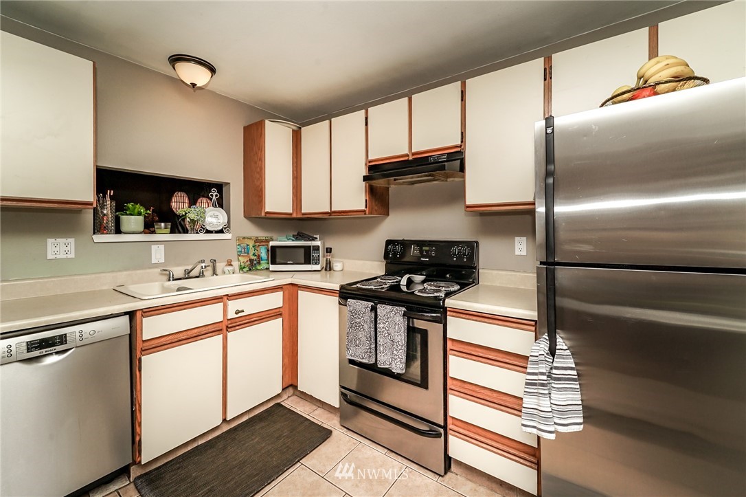 4109 Northeast 5th Street Renton, WA 98059 - Photo 9 of 26 a kitchen with stainless steel appliances granite countertop a refrigerator and a stove