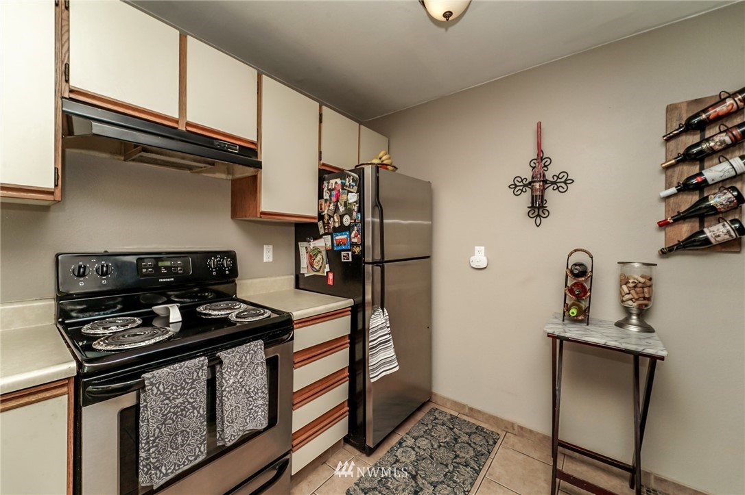 4109 Northeast 5th Street Renton, WA 98059 - Photo 10 of 26 a kitchen with stainless steel appliances granite countertop a stove and a refrigerator