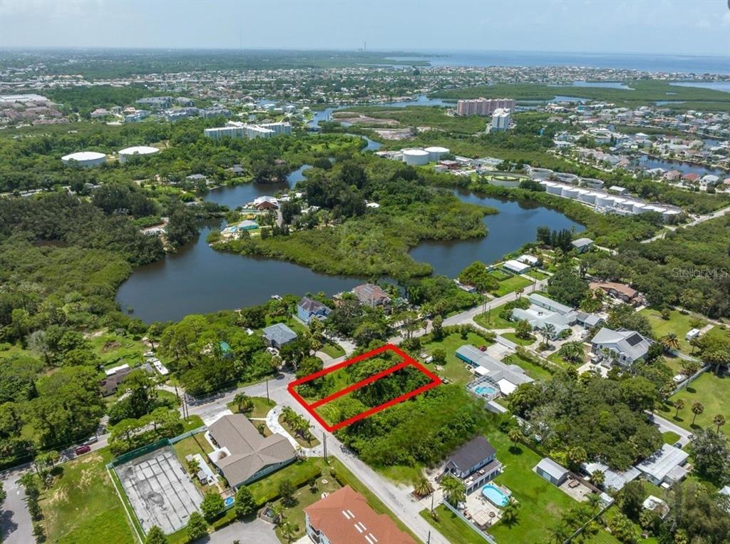 6307 Oelsner Street, Unit 11&12 New Port Richey, FL 34652 - Photo 1 of 11 an aerial view of residential houses with outdoor space and trees
