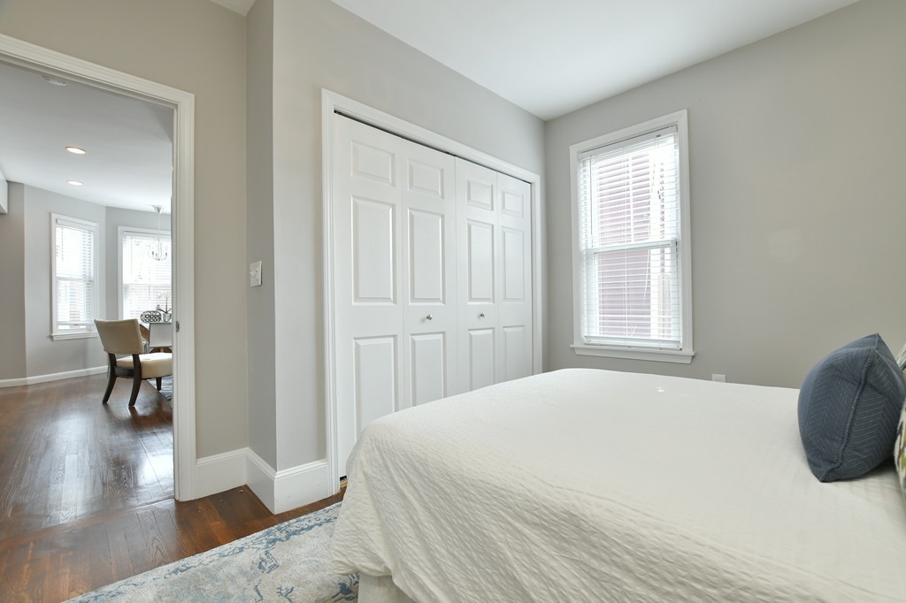 11 Atwood Square, Unit 1 Boston, MA 02130 - Photo 11 of 23 a spacious bedroom with a bed and a table in it