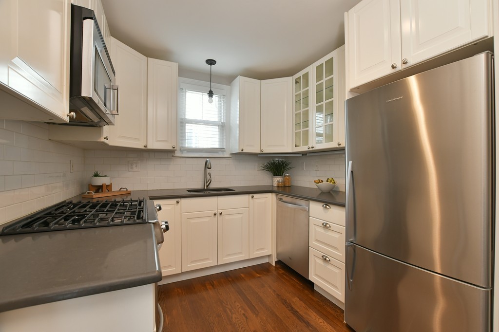 11 Atwood Square, Unit 1 Boston, MA 02130 - Photo 2 of 23 a kitchen with stainless steel appliances a refrigerator a sink and wooden cabinets