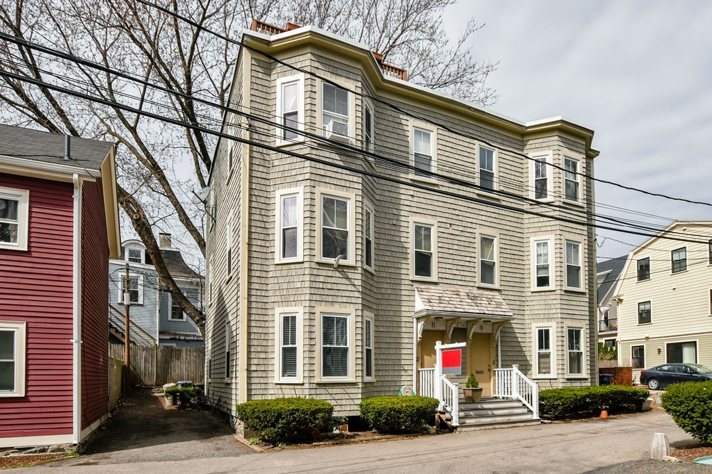 11 Atwood Square, Unit 1 Boston, MA 02130 - Photo 4 of 23 a front view of a building and a yard