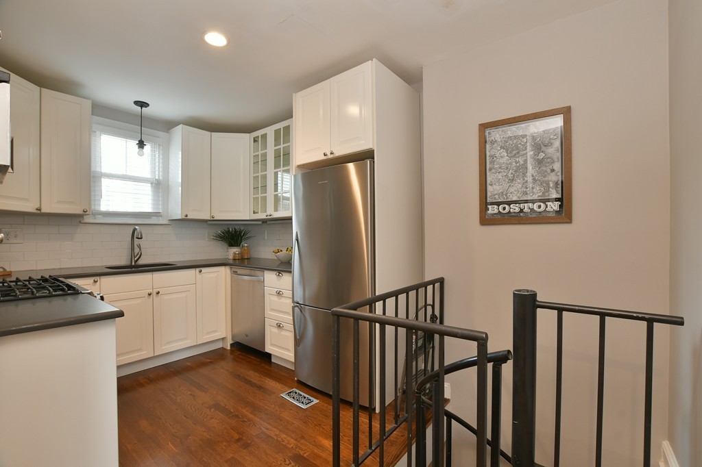 11 Atwood Square, Unit 1 Boston, MA 02130 - Photo 5 of 23 a kitchen with stainless steel appliances granite countertop a refrigerator sink and white cabinets