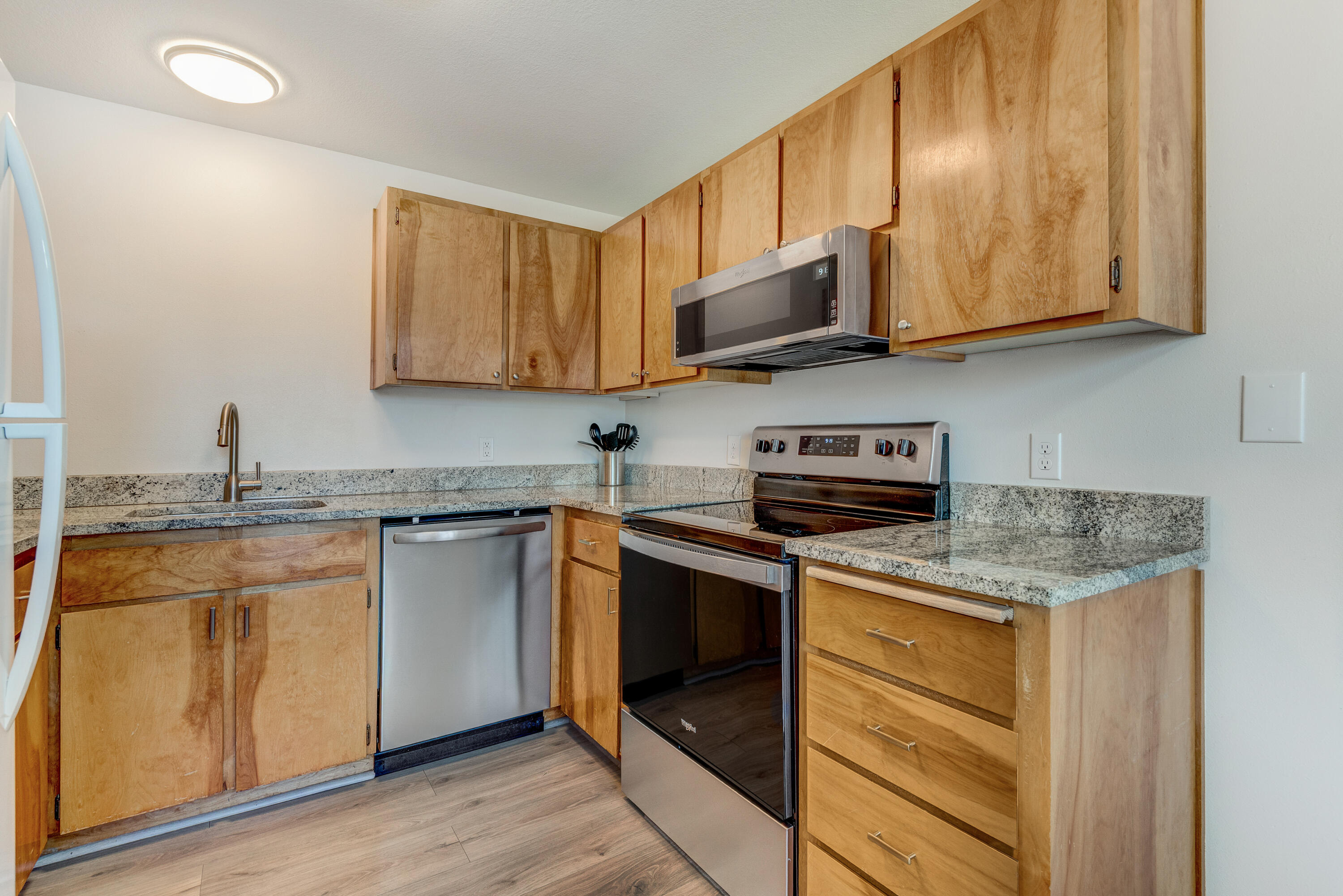 1916 Northeast Wichita Way Bend, OR 97701 - Photo 28 of 38 a kitchen with stainless steel appliances granite countertop a sink stove and microwave