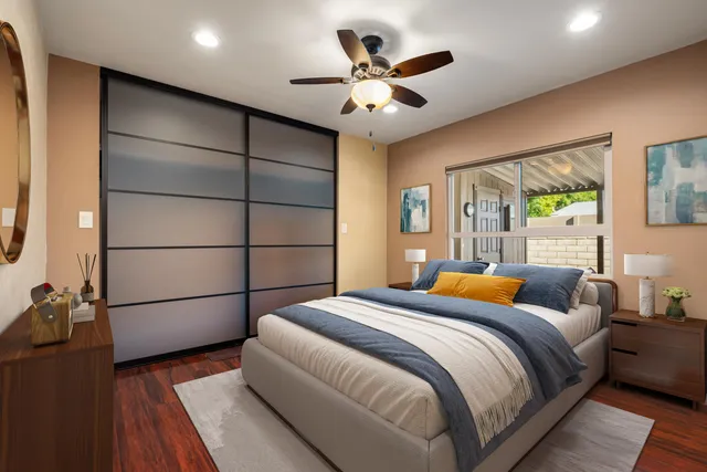 a bedroom with a large bed and a chandelier