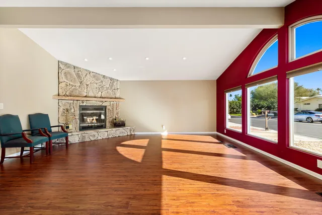 a view of livingroom with furniture fire place and wooden floor