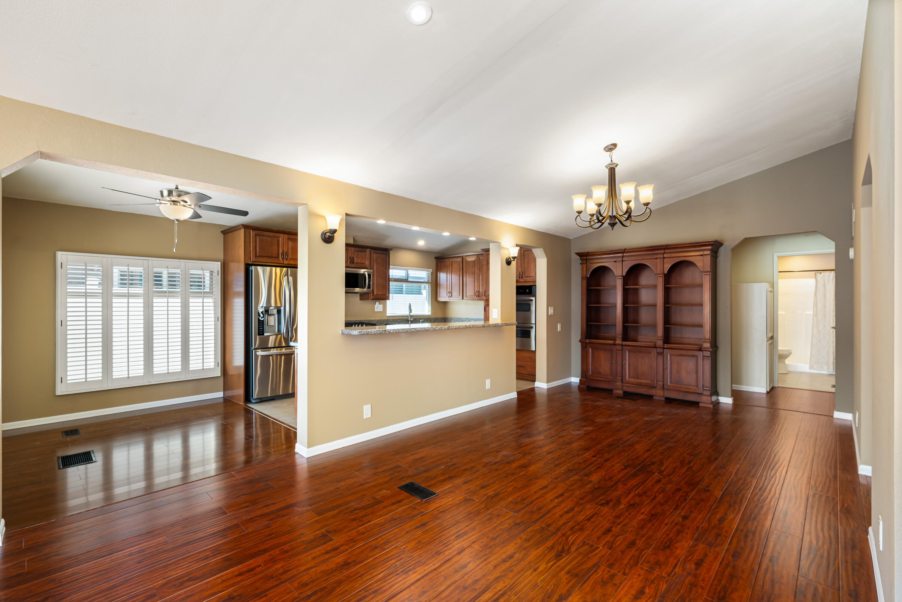 74096 Angels Cp Road Palm Desert, CA 92260 - Photo 27 of 33 a view of an empty room with wooden floor and a kitchen