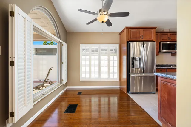 a hallway with wooden floor chandelier