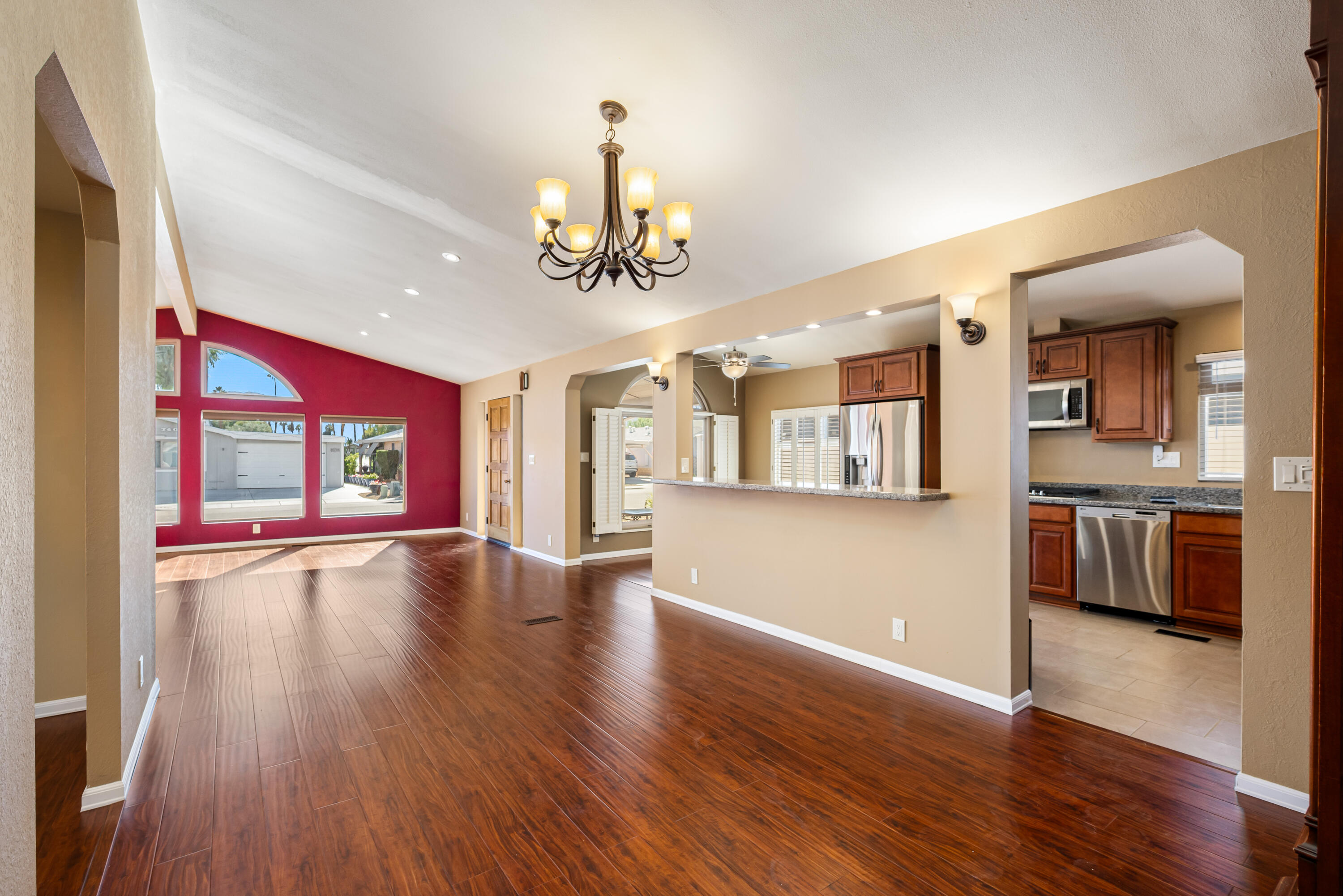74096 Angels Cp Road Palm Desert, CA 92260 - Photo 5 of 33 a view of an empty room with wooden floor and a kitchen
