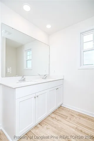 a view of a small space with wooden floor and a window