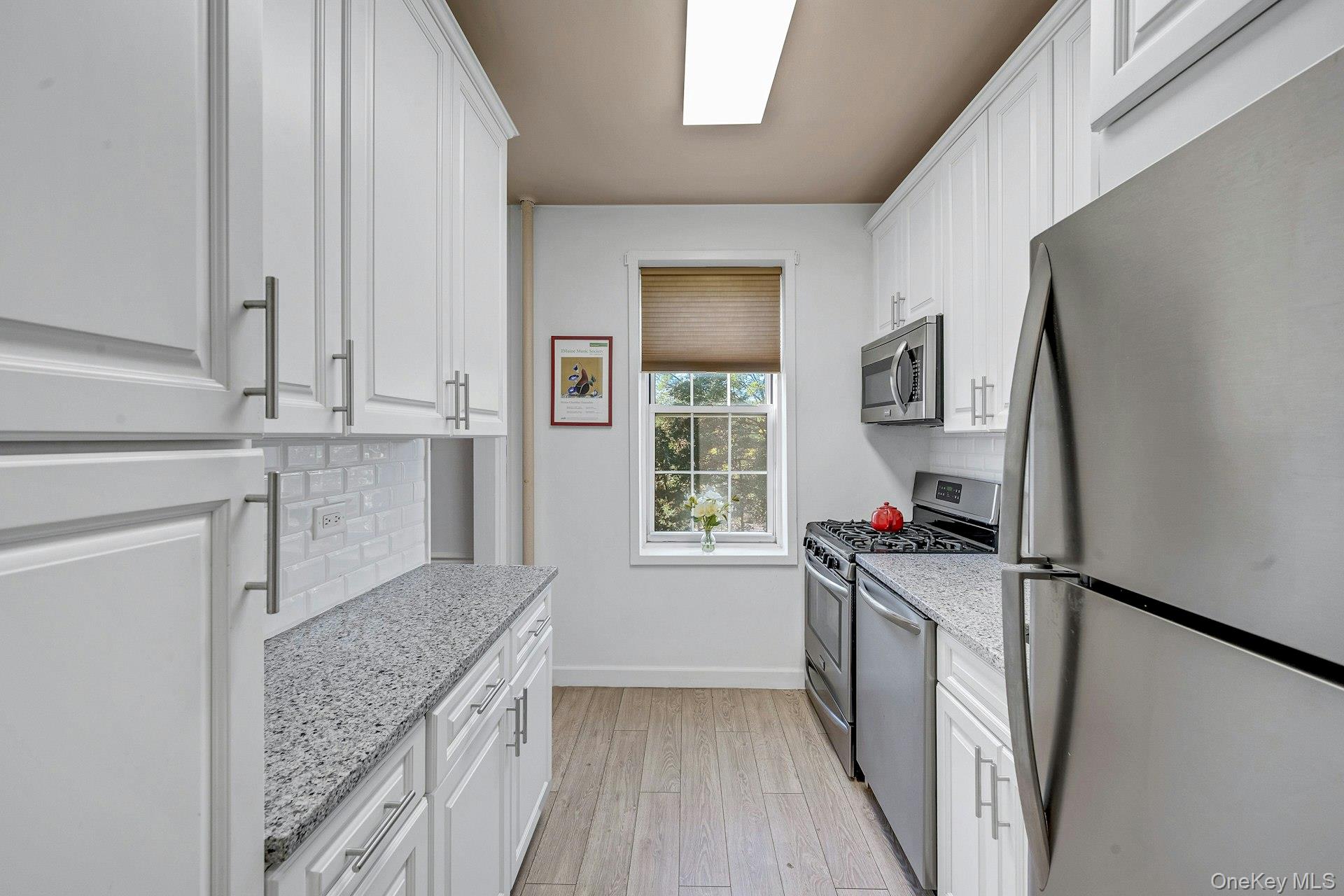 3 Midland Gardens, Unit 3H Bronxville, NY 10708 - Photo 13 of 20 a kitchen with a sink stove and refrigerator