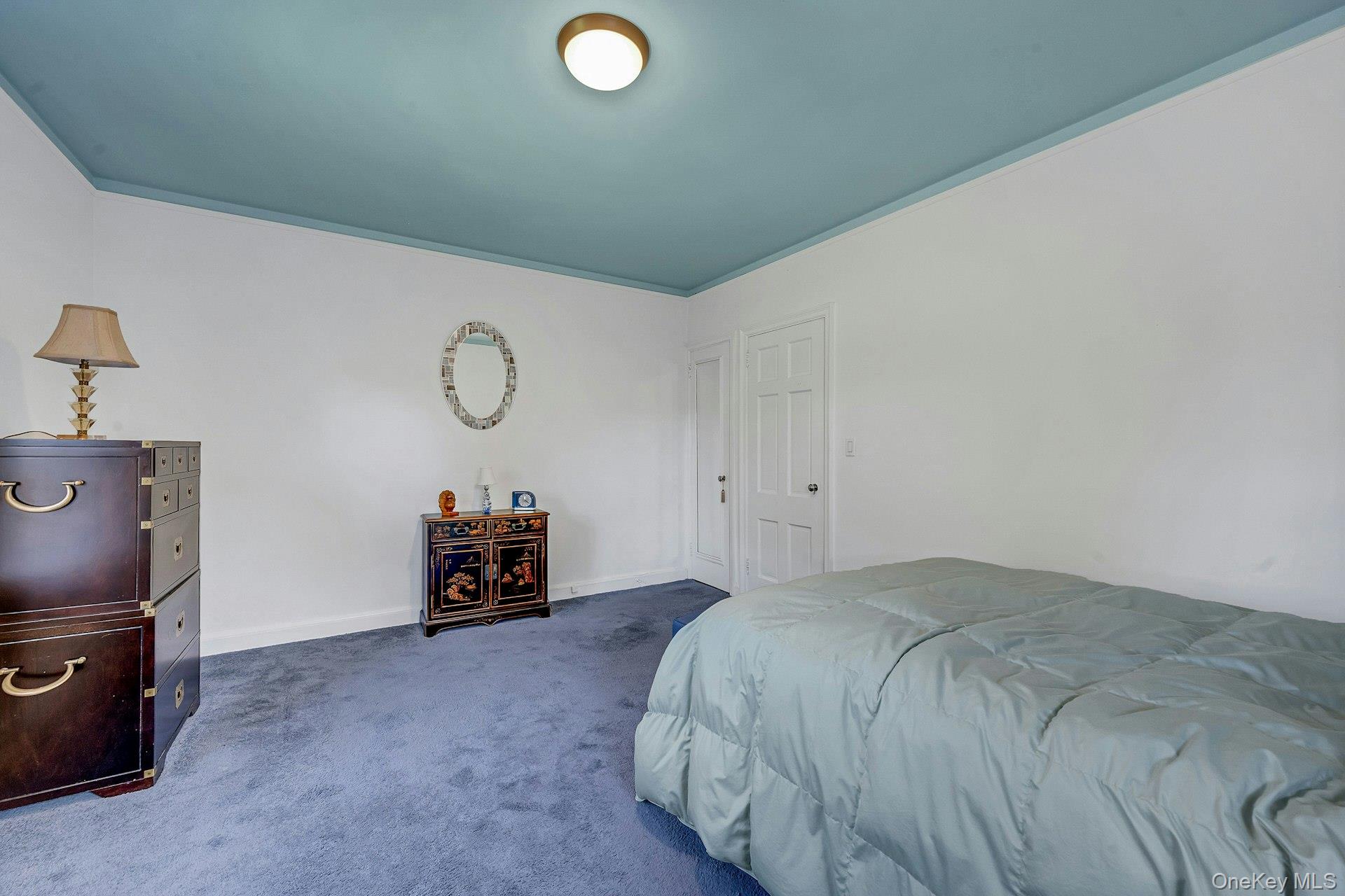 3 Midland Gardens, Unit 3H Bronxville, NY 10708 - Photo 16 of 20 a bedroom with a bed and cabinets