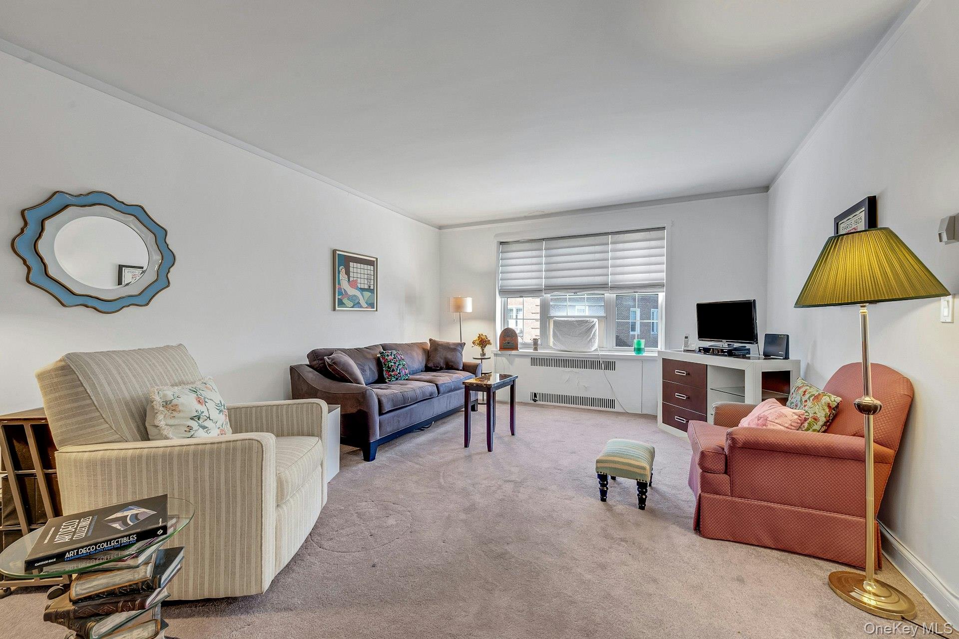 3 Midland Gardens, Unit 3H Bronxville, NY 10708 - Photo 7 of 20 a living room with furniture a flat screen tv and a window