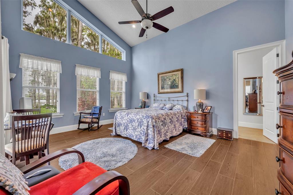 1134 Kelso Boulevard Windermere, FL 34786 - Photo 12 of 37 a spacious bedroom with a bed and a chandelier