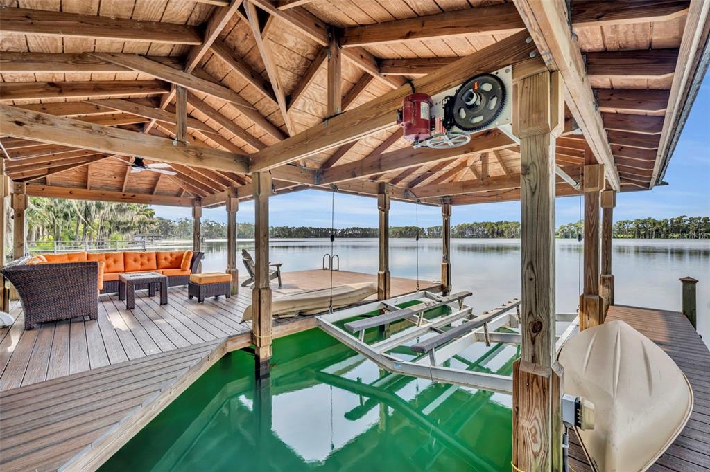 1134 Kelso Boulevard Windermere, FL 34786 - Photo 22 of 37 a view of a patio with a table and chairs under an umbrella with a patio