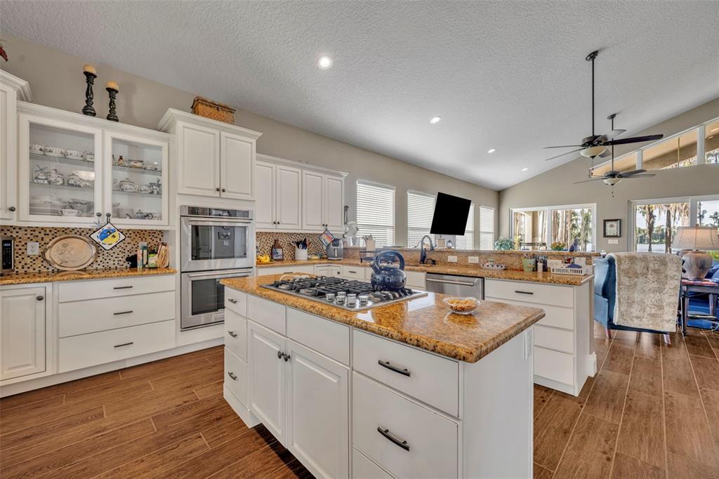 1134 Kelso Boulevard Windermere, FL 34786 - Photo 10 of 37 a open kitchen with stainless steel appliances granite countertop a stove and white cabinets