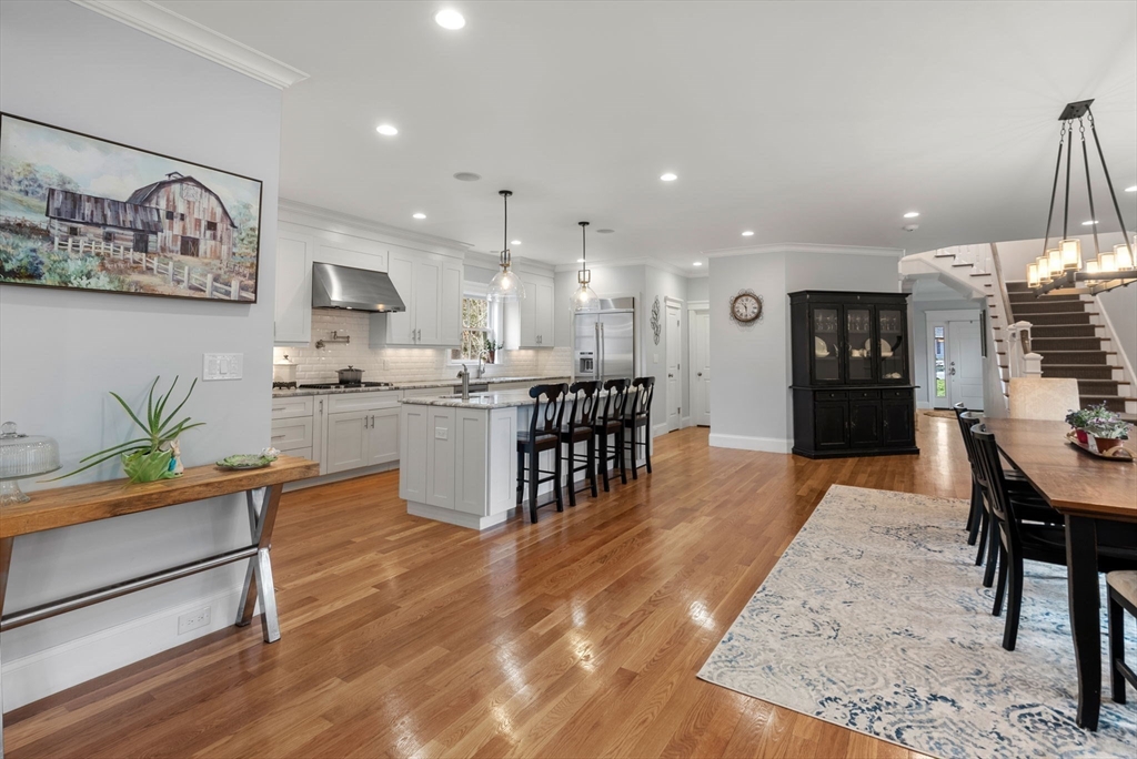 20 Manor Avenue Wellesley, MA 02482 - Photo 9 of 32 a large kitchen with stainless steel appliances kitchen island granite countertop a table and chairs in it