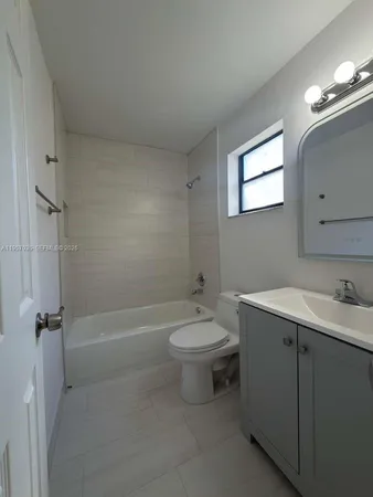a bathroom with a toilet a sink and bathtub