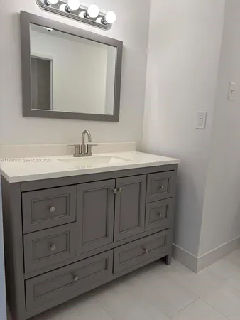 a bathroom with a double vanity sink and mirror