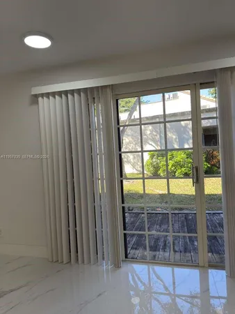 a view of entryway with a floor to ceiling window and wooden floor