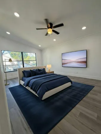 a bedroom with bed and window