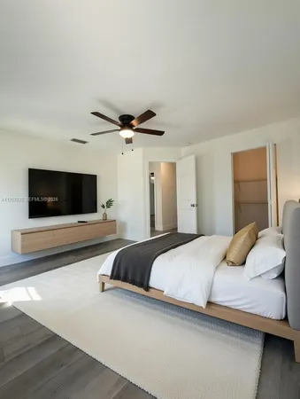 a bedroom with a large bed and a chandelier