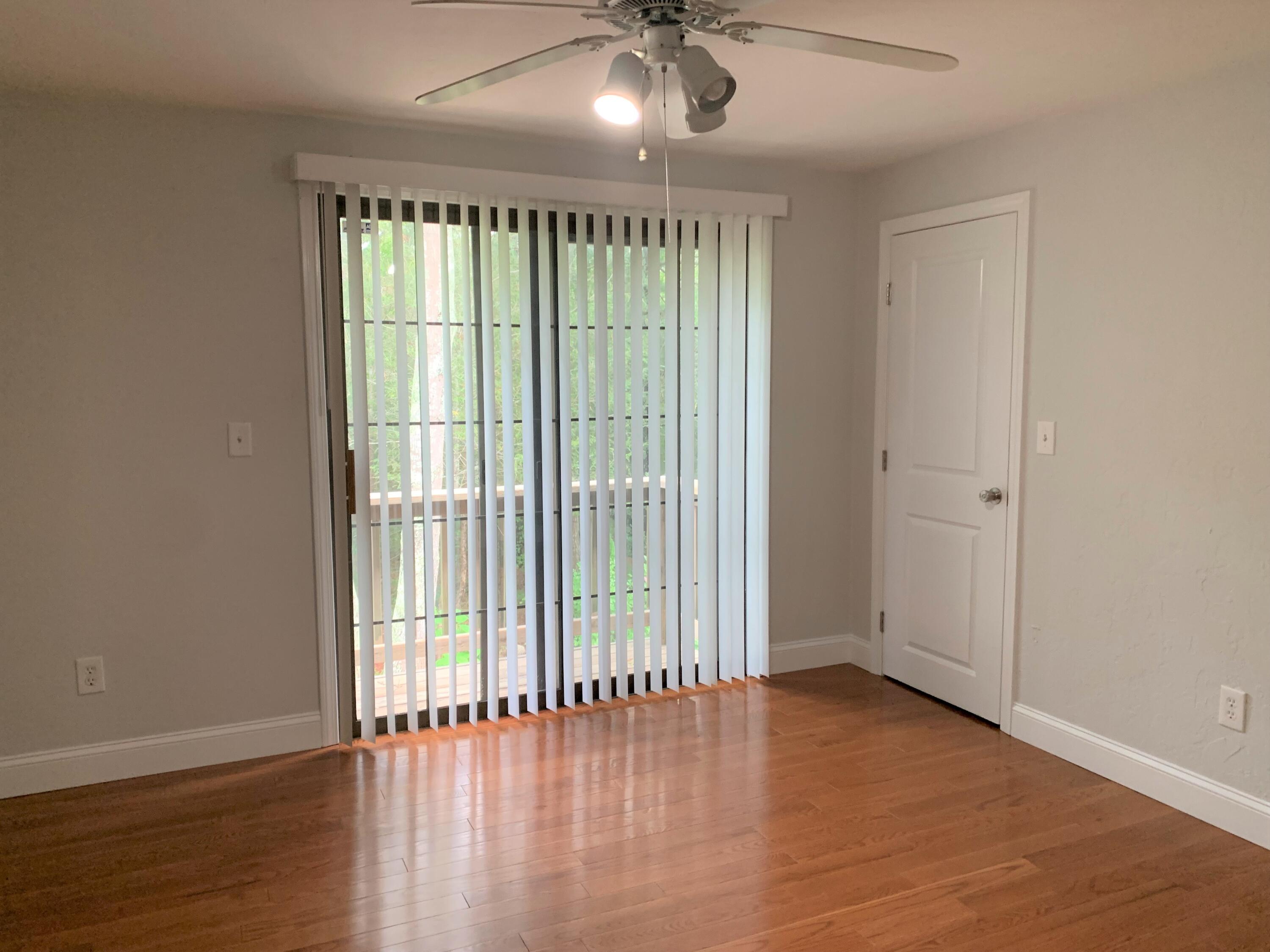 195 Falmouth Road, Unit 19D Mashpee, MA 02649 - Photo 14 of 17 wooden floor in an empty room with a window