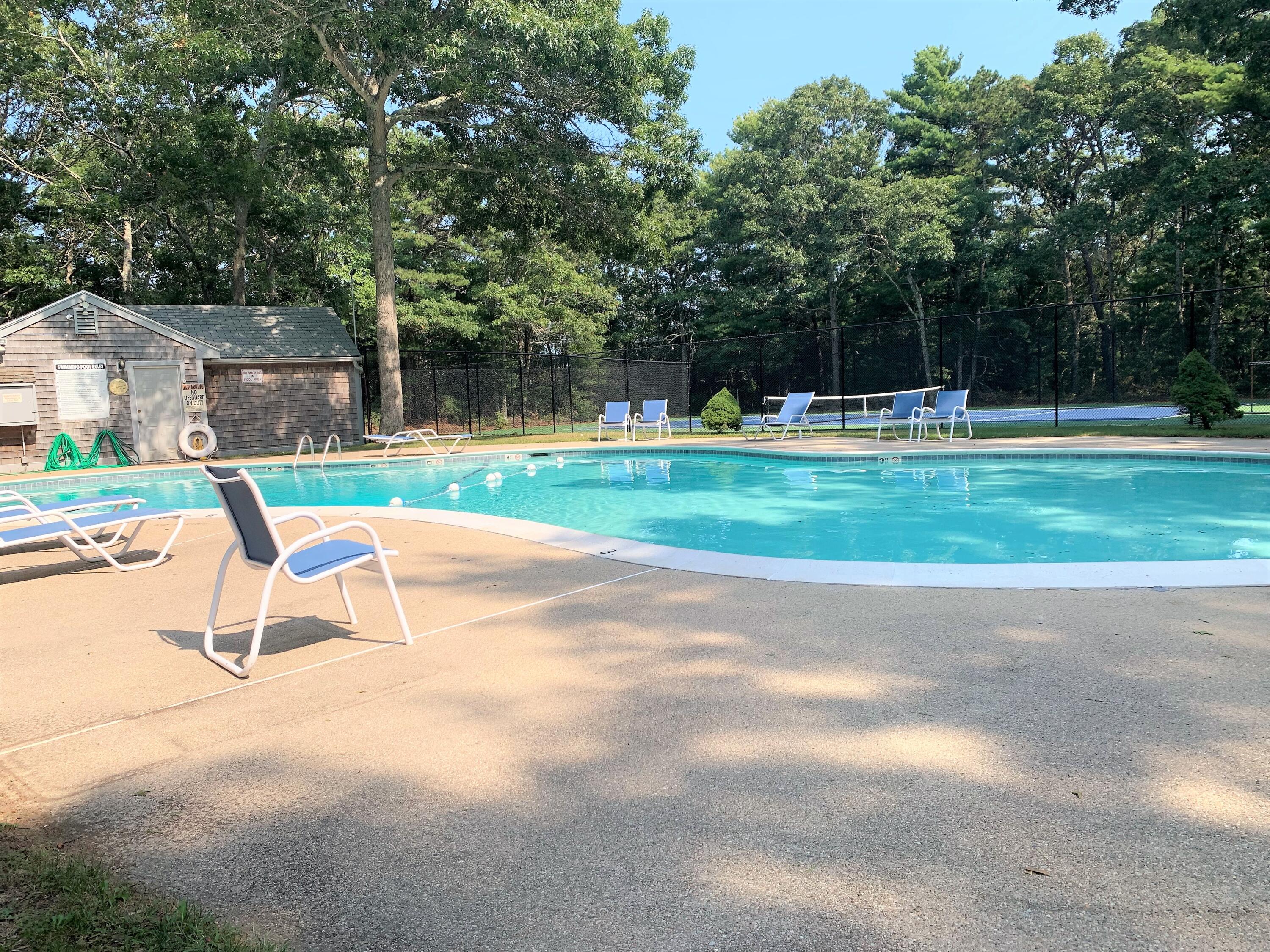 195 Falmouth Road, Unit 19D Mashpee, MA 02649 - Photo 16 of 17 a view of backyard with a garden and slide