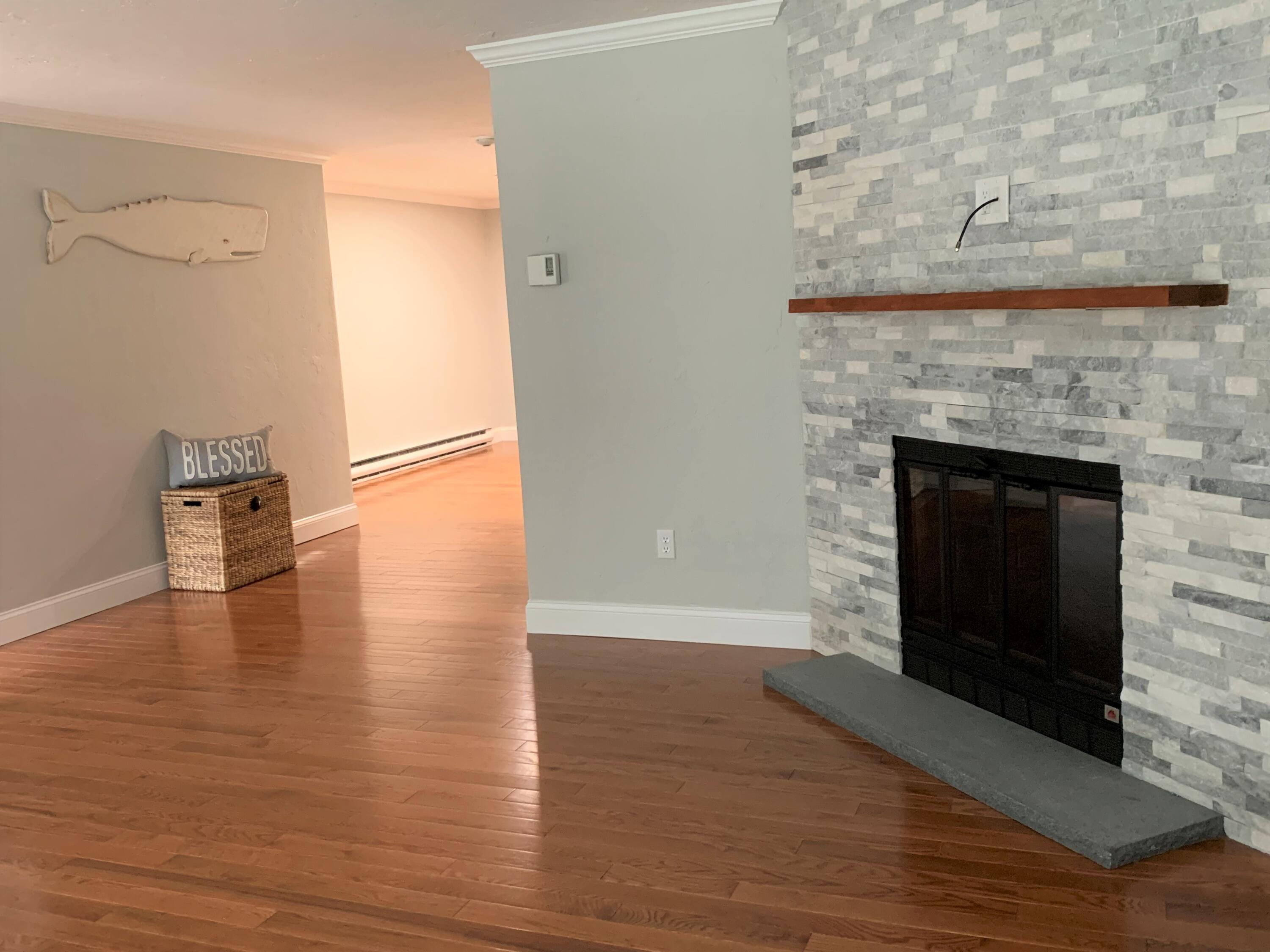 195 Falmouth Road, Unit 19D Mashpee, MA 02649 - Photo 4 of 17 a view of a livingroom with wooden floor