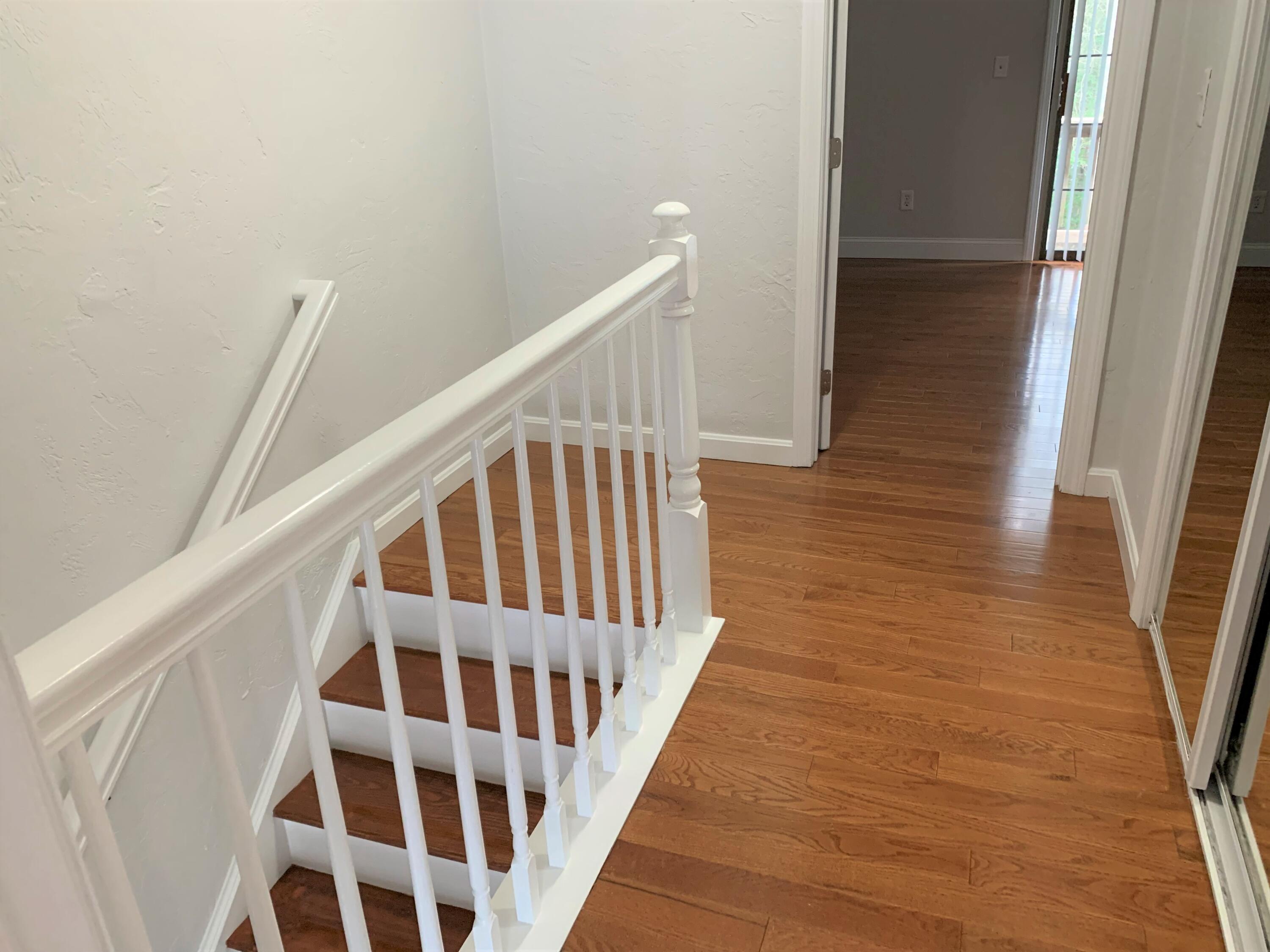 195 Falmouth Road, Unit 19D Mashpee, MA 02649 - Photo 9 of 17 a view of staircase with wooden floor and white walls