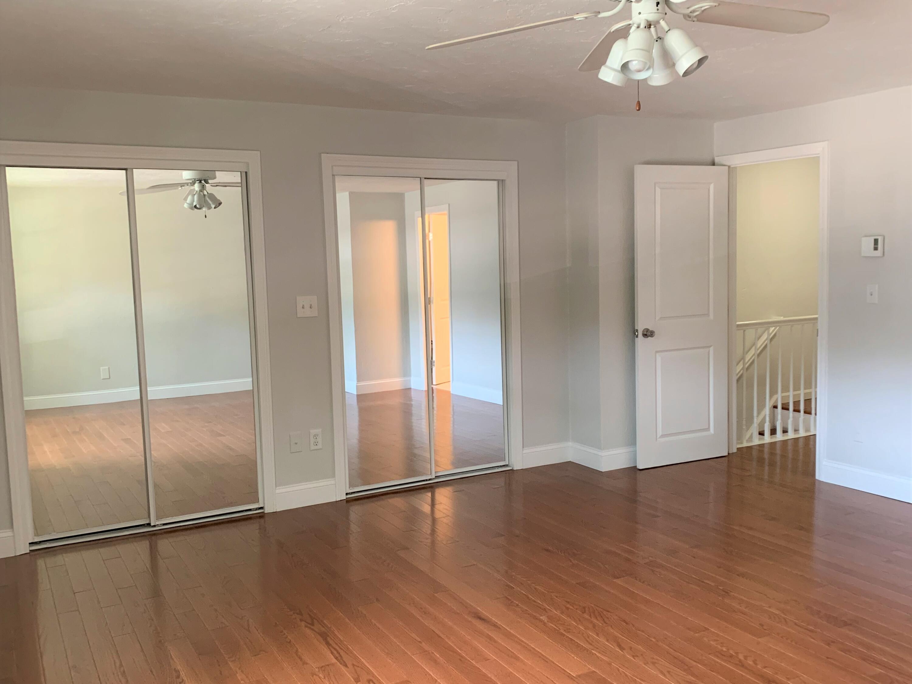 195 Falmouth Road, Unit 19D Mashpee, MA 02649 - Photo 10 of 17 a view of an empty room with wooden floor