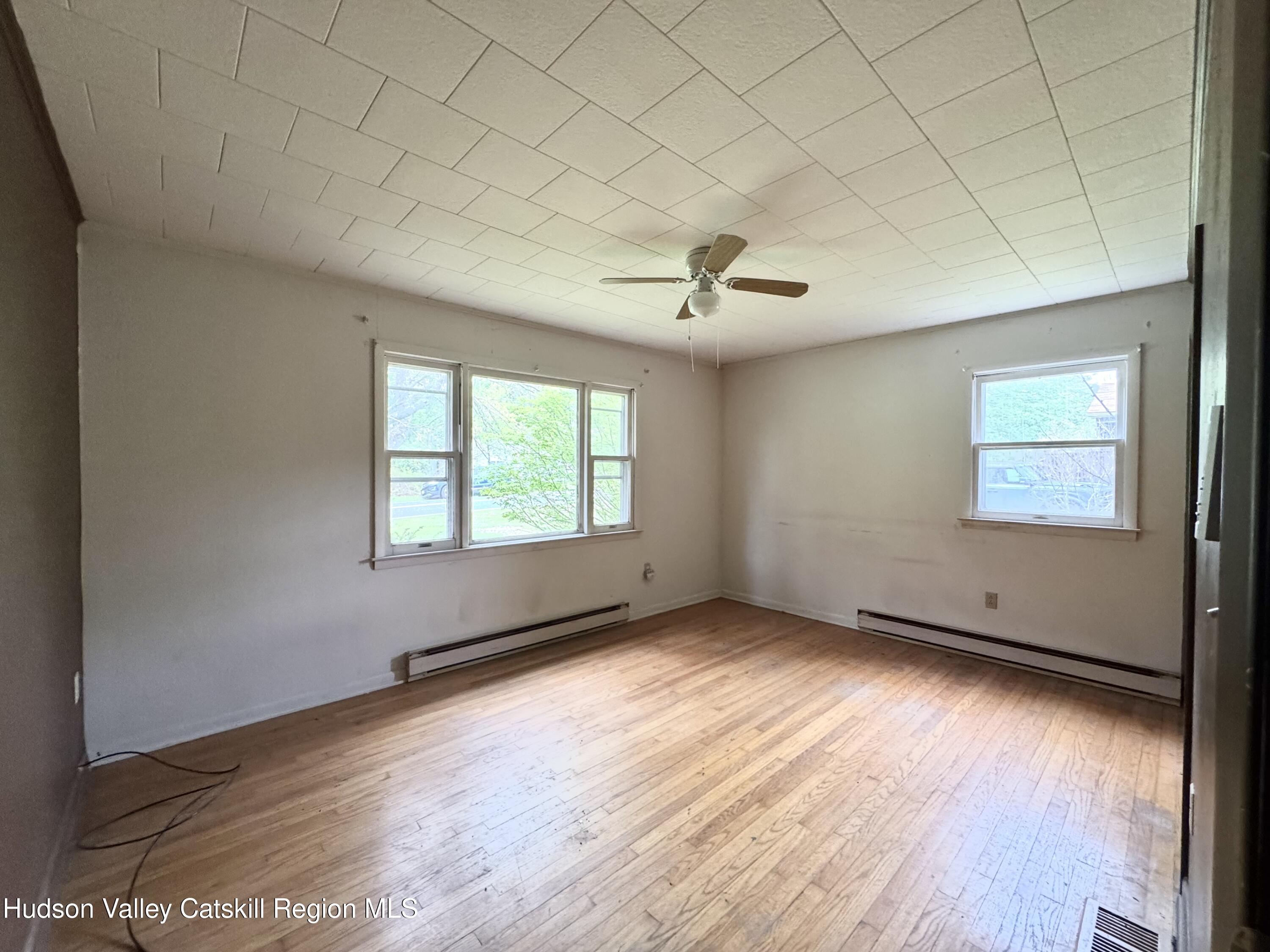 752 Old Rte 23 Acra, NY 12405 - Photo 13 of 25 a view of an empty room with wooden floor and a window