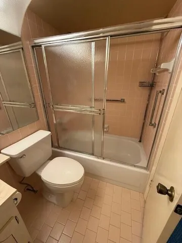a bathroom with a toilet and a shower