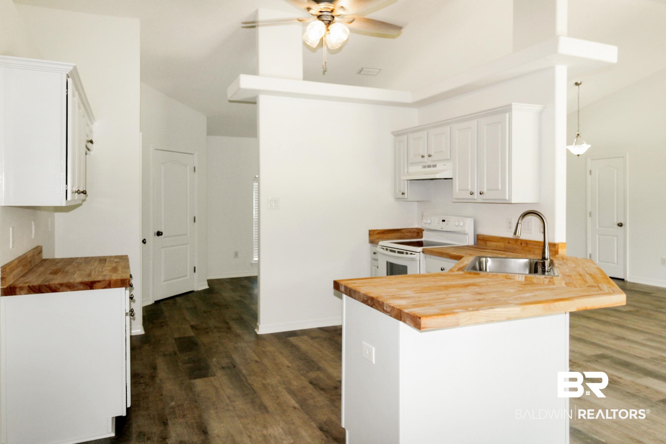 14750 Pawnee Court Foley, AL 36535 - Photo 18 of 34 Kitchen with butcher block counters, ceiling fan, white range with electric stovetop, a peninsula, and dark wood-style flooring