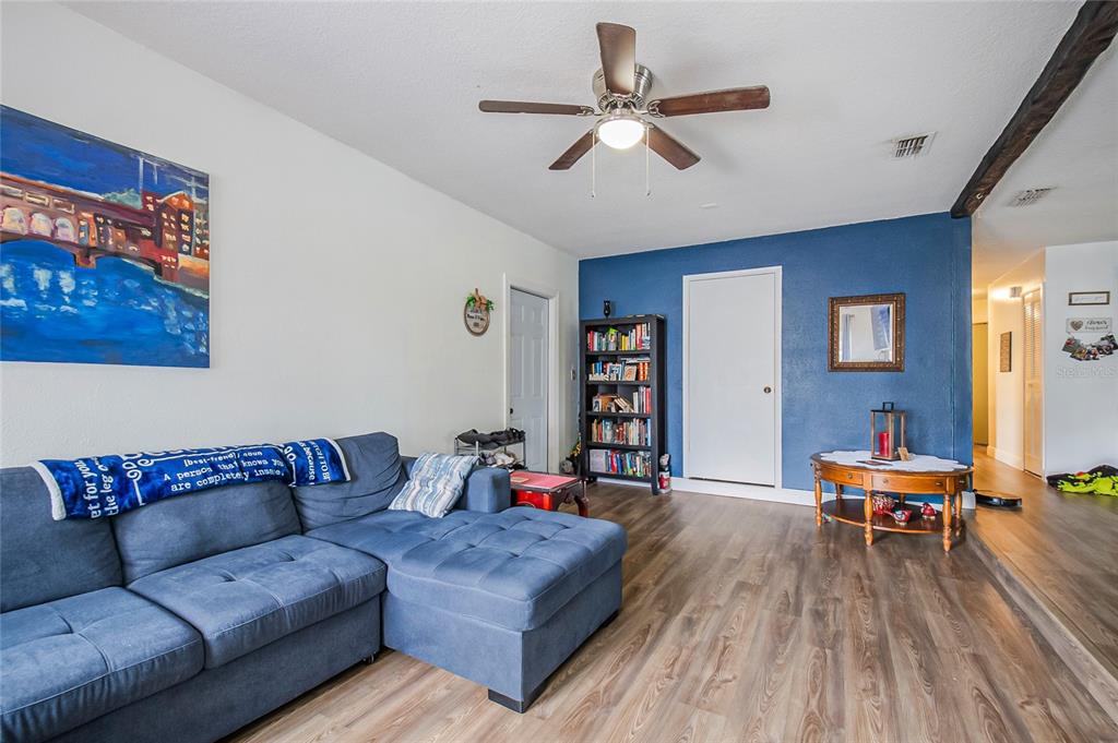 4432 Watch Hill Road Orlando, FL 32808 - Photo 12 of 30 a living room with furniture and a wooden floor