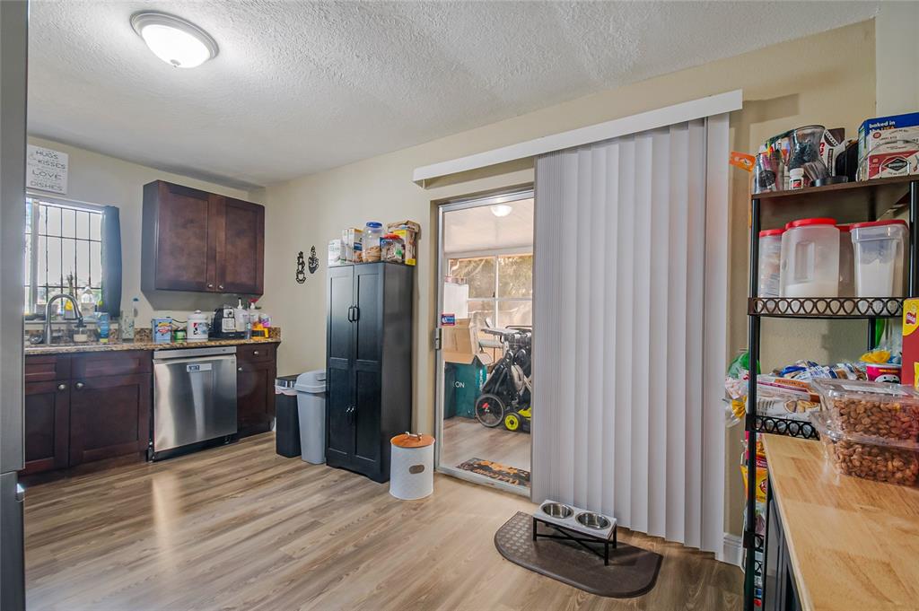 4432 Watch Hill Road Orlando, FL 32808 - Photo 16 of 30 a kitchen with stainless steel appliances granite countertop a refrigerator and a sink
