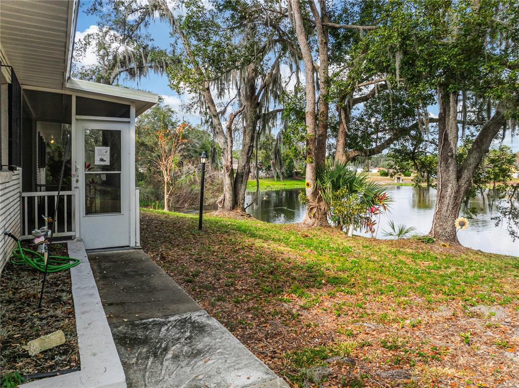 4432 Watch Hill Road Orlando, FL 32808 - Photo 3 of 30 a view of a yard with plants and large trees