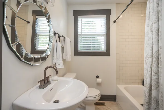 a bathroom with a sink a toilet and a bathtub