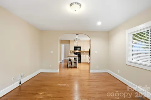 a view of a living room a dining room with furniture and a window