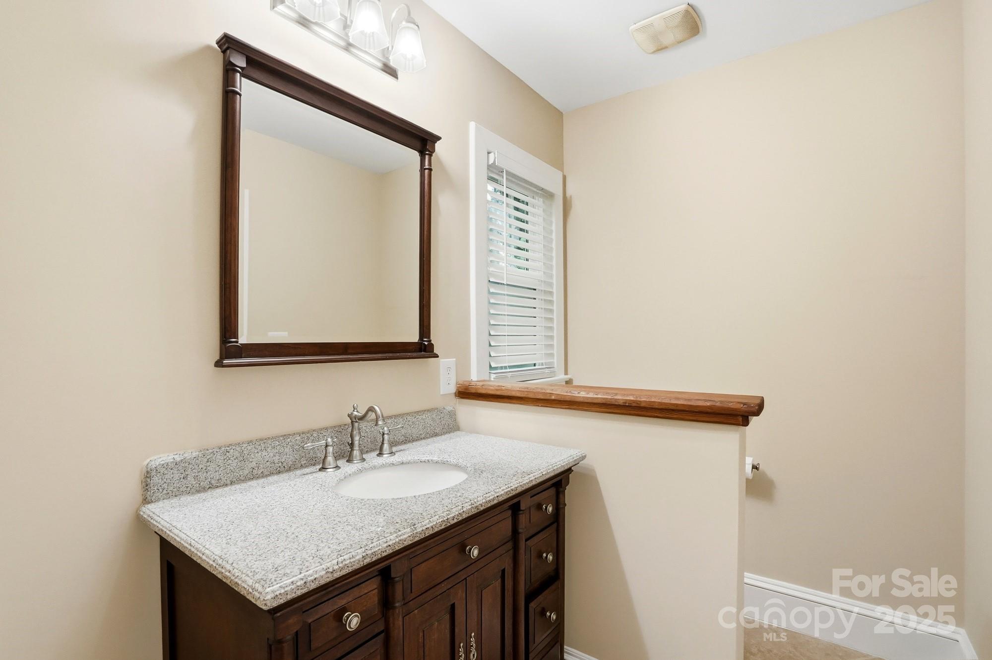 3108 Westmoreland Avenue Charlotte, NC 28205 - Photo 14 of 27 a bathroom with a sink vanity and a mirror