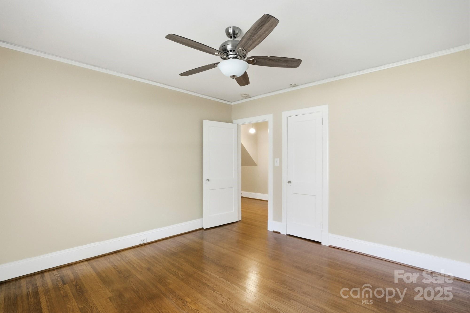 3108 Westmoreland Avenue Charlotte, NC 28205 - Photo 17 of 27 an empty room with wooden floor and ceiling fan