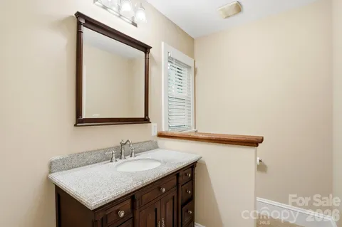 a bathroom with a sink vanity and a mirror