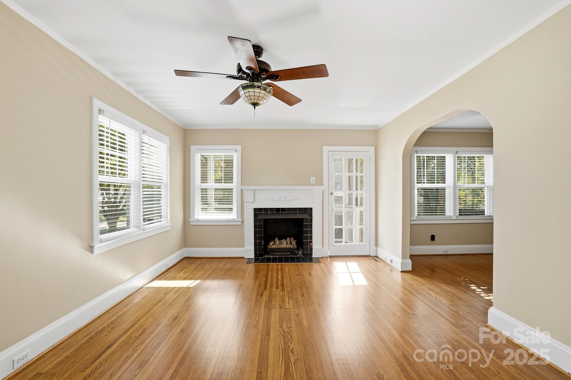 3108 Westmoreland Avenue Charlotte, NC 28205 - Photo 2 of 27 a view of a livingroom with wooden floor a fireplace and windows