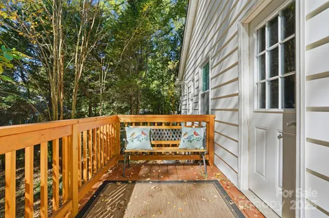 a view of balcony with wooden floor and fence